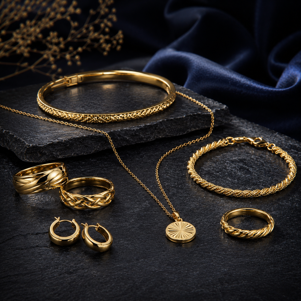 Luxurious gold jewelry flatlay on slate